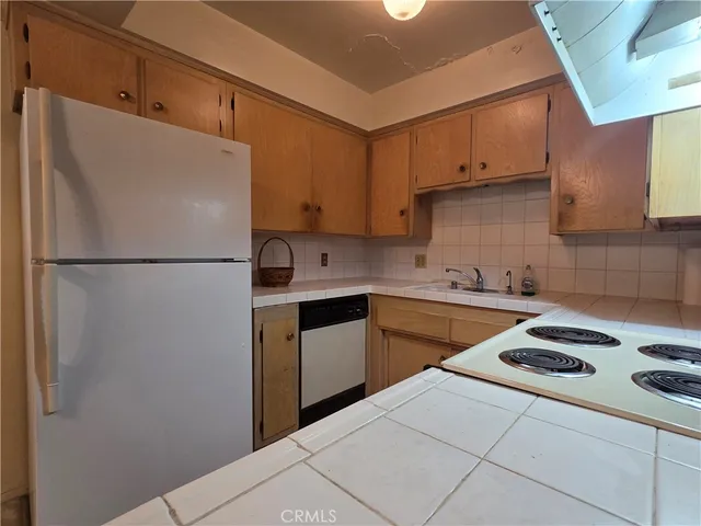 a kitchen with a stove and a refrigerator