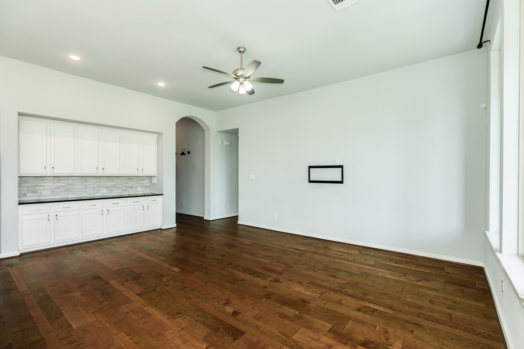 4015 Shackleton Court Iowa Colony, TX 77583 - Photo 7 of 50 Spacious open-concept living area featuring stunning, high-durability flooring throughout. This bright space offers a seamless flow and highlights the elegant entrance to the primary bedroom suite.