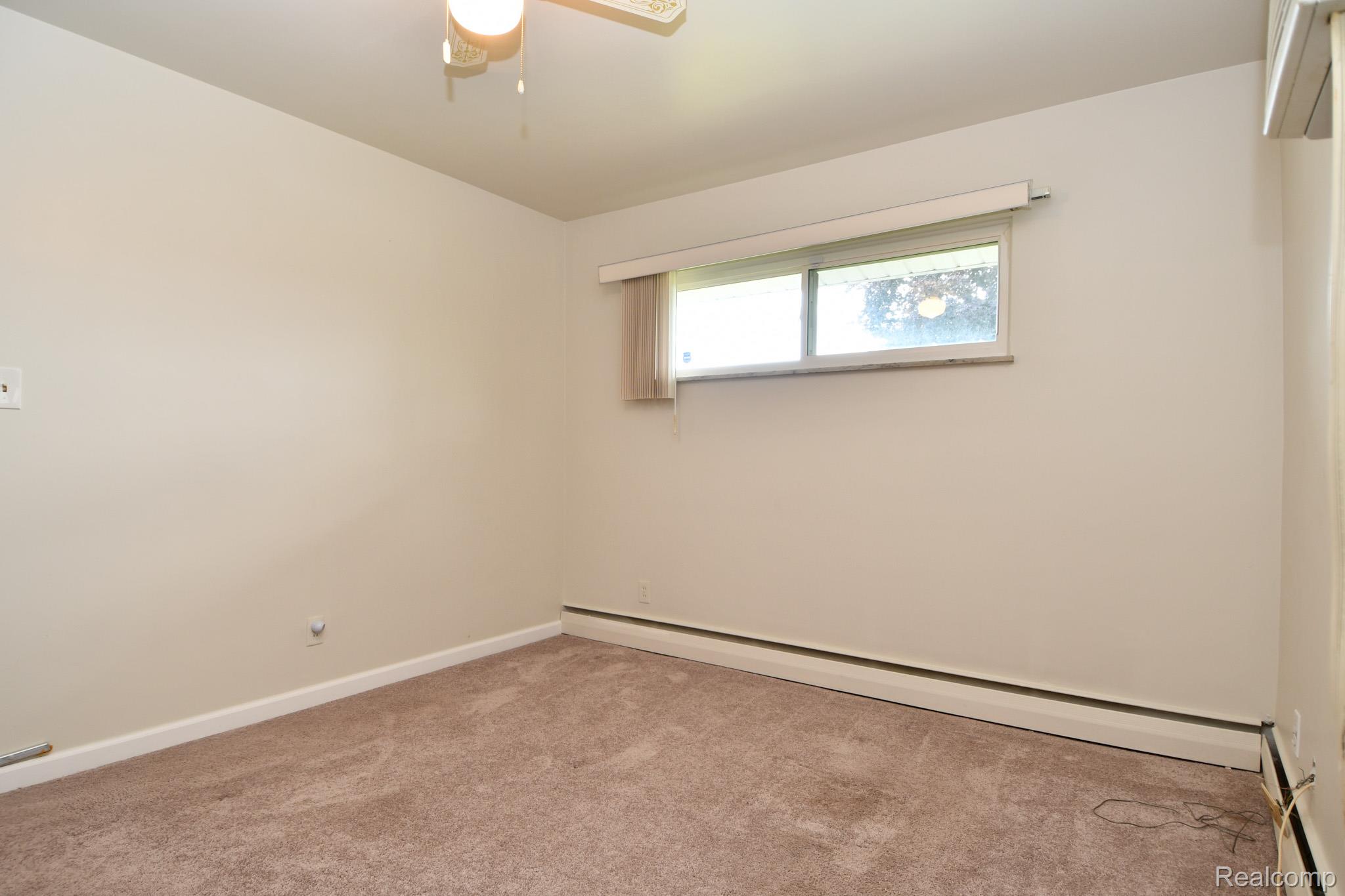 6443 Richfield Road Flint, MI 48506 - Photo 17 of 40 2nd bedroom with baseboard heating, carpet, and a ceiling fan