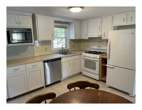 32 Lake Road Yarmouth, MA 02673 - Photo 7 of 17 a kitchen with cabinets stainless steel appliances and sink