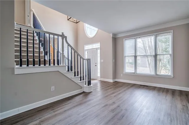 wooden floor in an empty room with a window