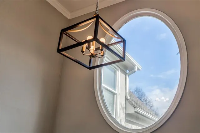 a large kitchen with stainless steel appliances a large counter top a stove a refrigerator and a sink