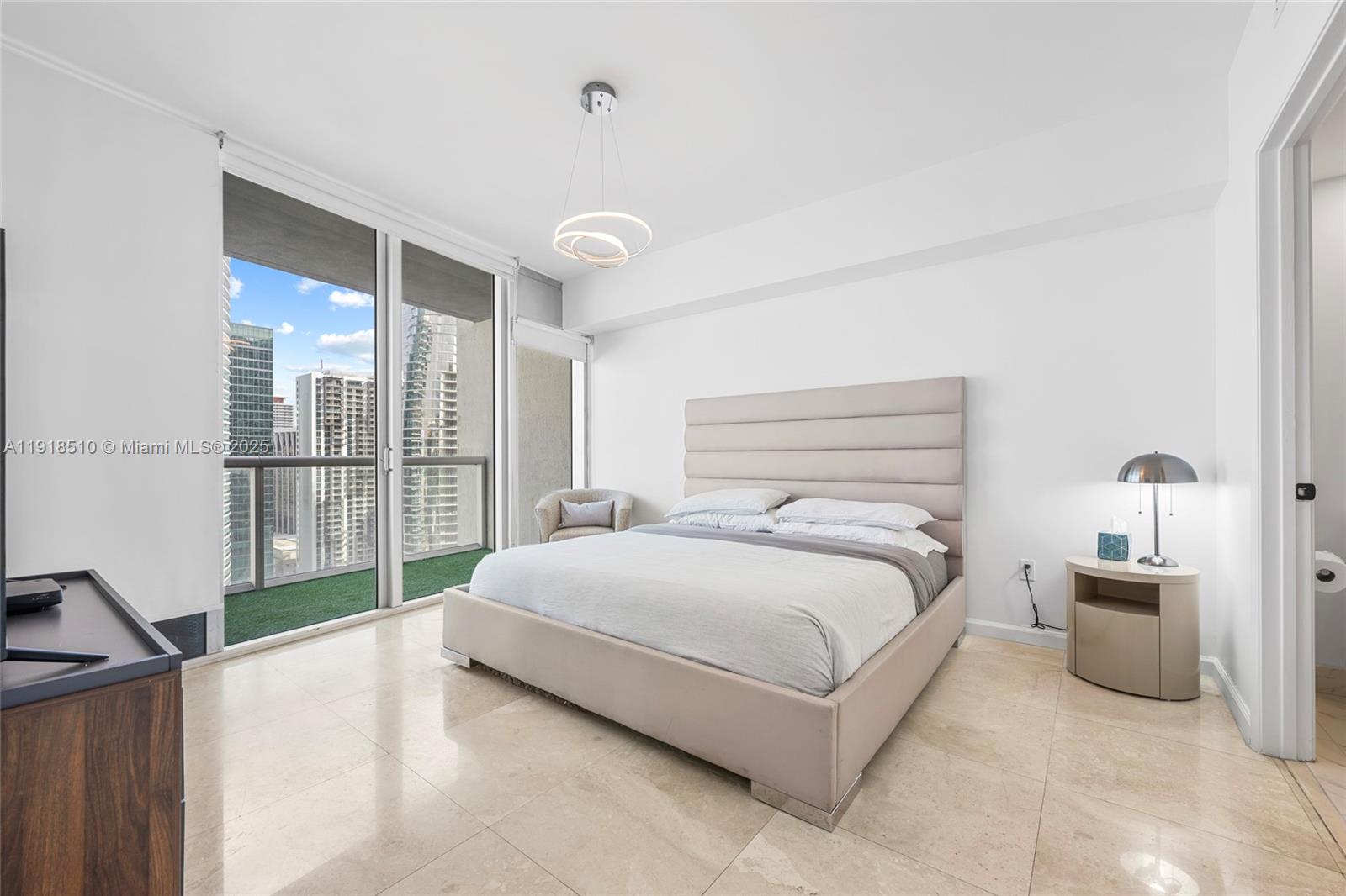 485 Brickell Avenue, Unit 3503 Miami, FL 33131 - Photo 16 of 23 a spacious bedroom with a bed and a large window