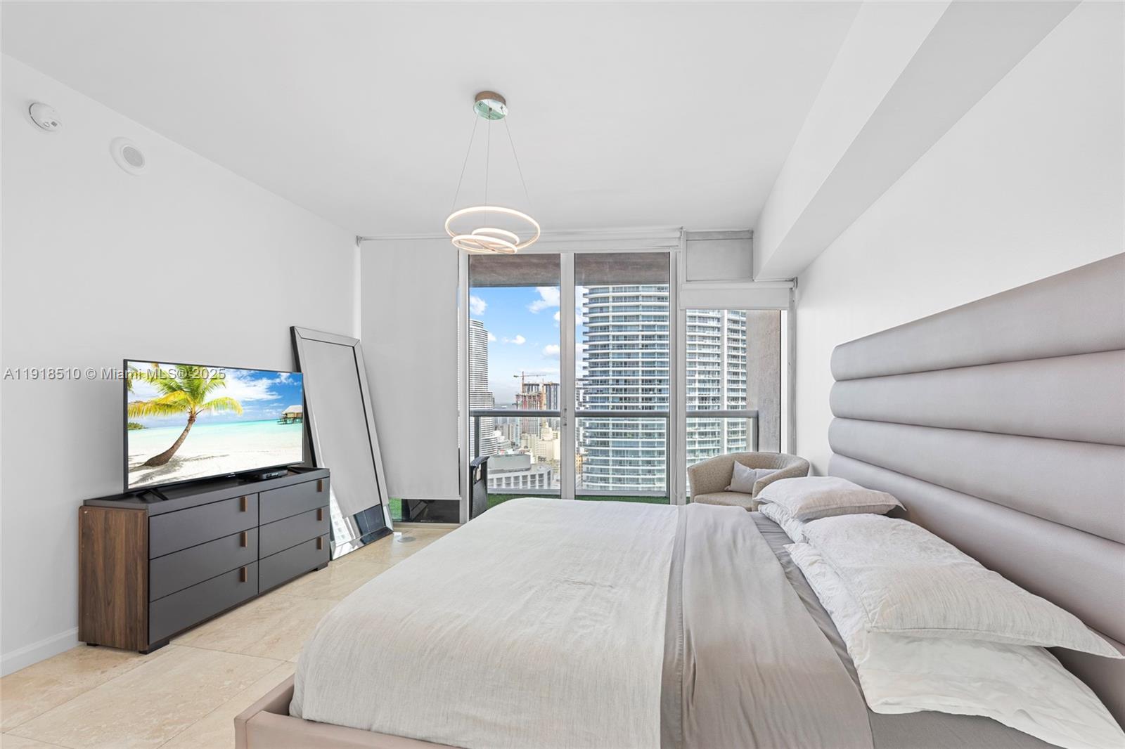 485 Brickell Avenue, Unit 3503 Miami, FL 33131 - Photo 18 of 23 a bedroom with a bed and a television