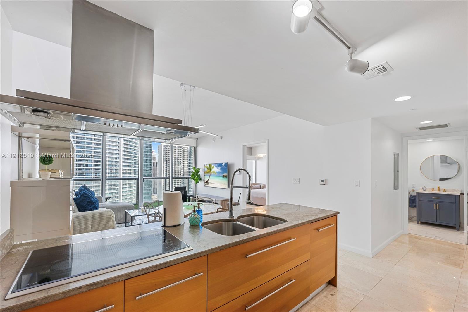 485 Brickell Avenue, Unit 3503 Miami, FL 33131 - Photo 6 of 23 a kitchen with sink refrigerator and window
