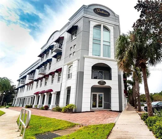 a front view of a building with a garden