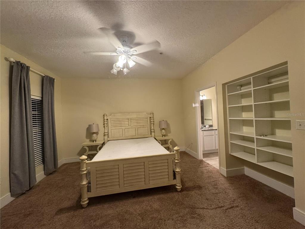 300 State Street East, Unit 206 Oldsmar, FL 34677 - Photo 11 of 23 a bedroom with a bed and a ceiling fan