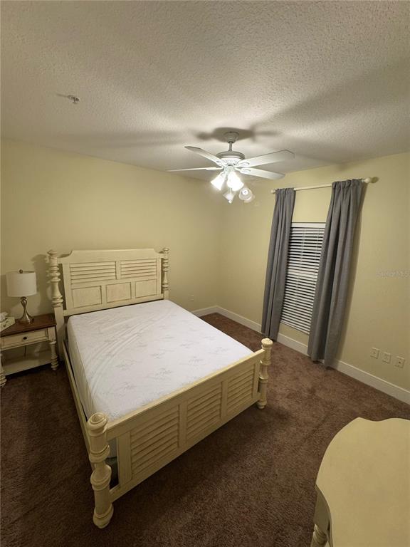 300 State Street East, Unit 206 Oldsmar, FL 34677 - Photo 15 of 23 a bedroom with a bed and a chandelier