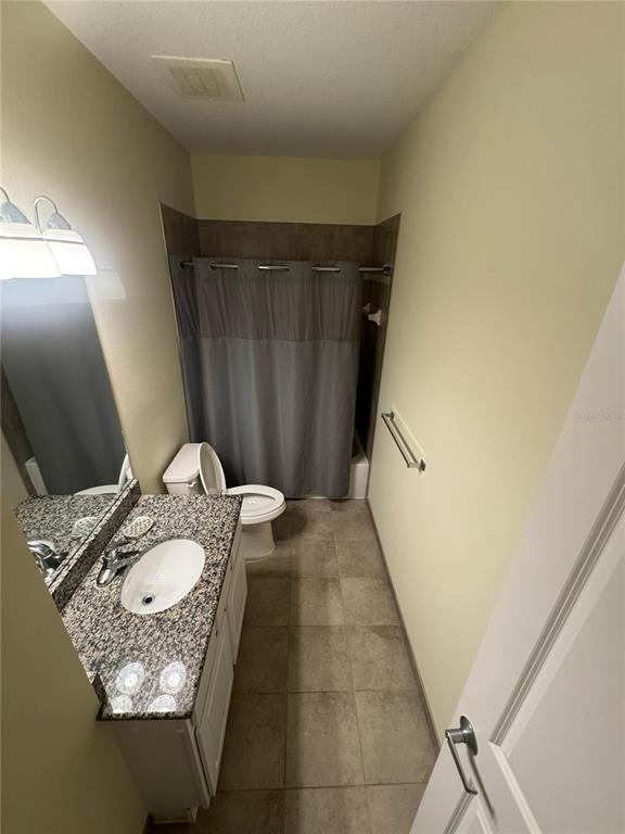 300 State Street East, Unit 206 Oldsmar, FL 34677 - Photo 17 of 23 a bathroom with a granite countertop sink and a mirror