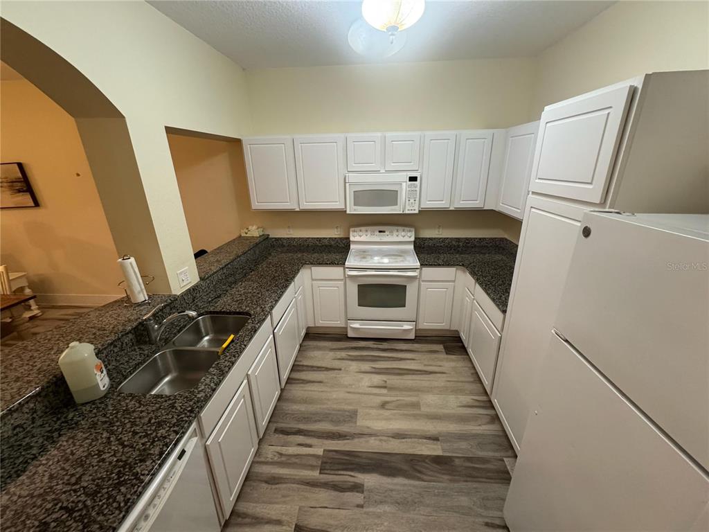 300 State Street East, Unit 206 Oldsmar, FL 34677 - Photo 2 of 23 a kitchen with a sink stove and refrigerator