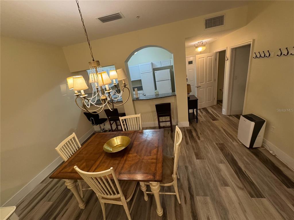 300 State Street East, Unit 206 Oldsmar, FL 34677 - Photo 4 of 23 a view of a dining room with furniture and chandelier