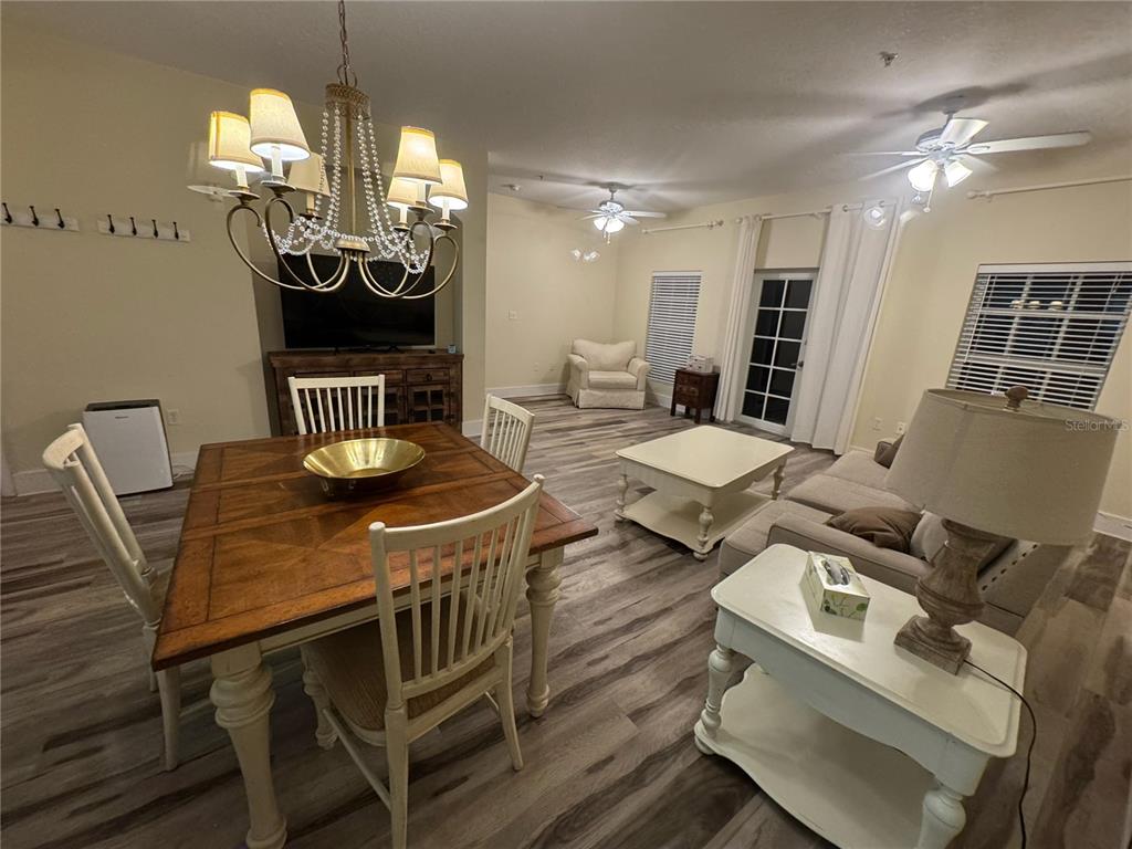 300 State Street East, Unit 206 Oldsmar, FL 34677 - Photo 6 of 23 a view of a dining room with furniture chandelier and wooden floor