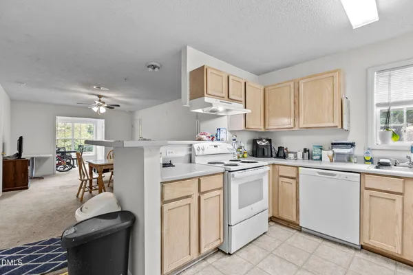 a kitchen with cabinets appliances and a window