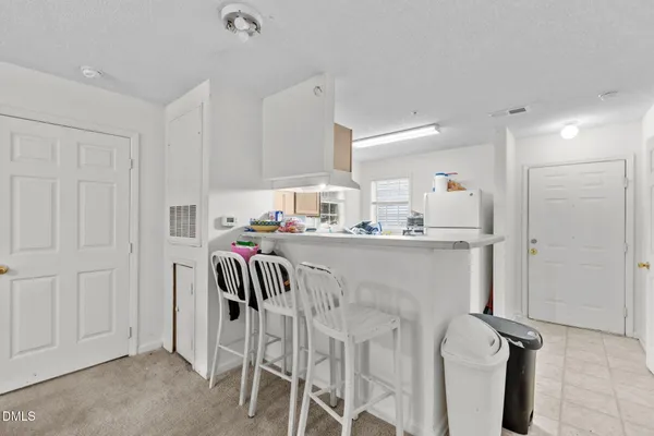 a kitchen with stainless steel appliances granite countertop a sink refrigerator and cabinets