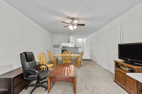 a view of a livingroom with furniture and a flat screen tv