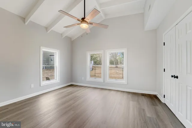 a view of a house with a yard and wooden fence