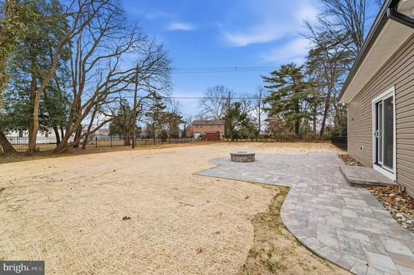 a view of a house with a yard and wooden fence