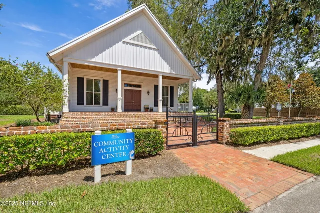 a view of a house with a yard and pathway