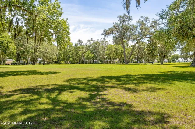 a view of a lake with houses in the back
