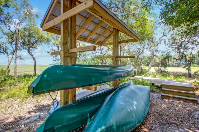 a view of a lake with a floor to ceiling window and a palm tree