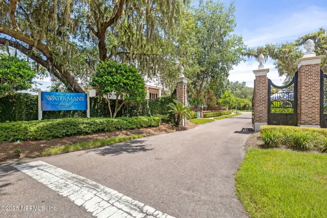 a view of a house with a big yard and large trees