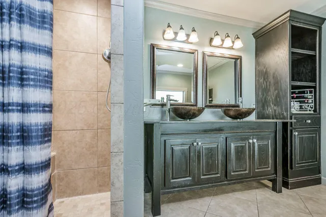 a bathroom with a double vanity sink and a mirror