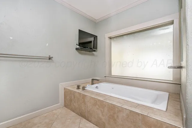 a spacious bathroom with a bathtub and a window
