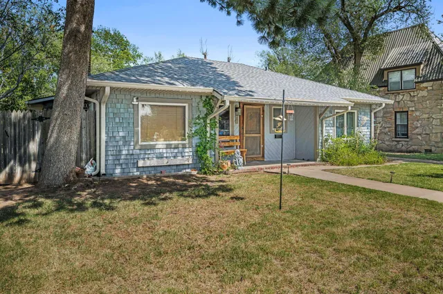 a house that has a tree in front of it