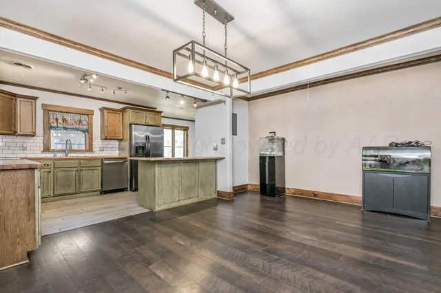 a view of a kitchen with a sink stainless steel appliances