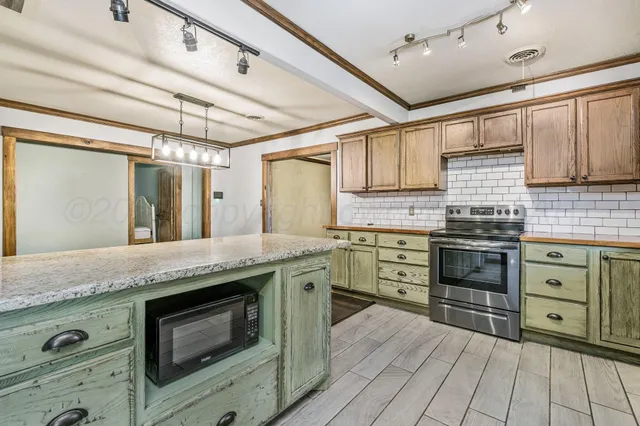 a kitchen with granite countertop stainless steel appliances and wooden cabinets