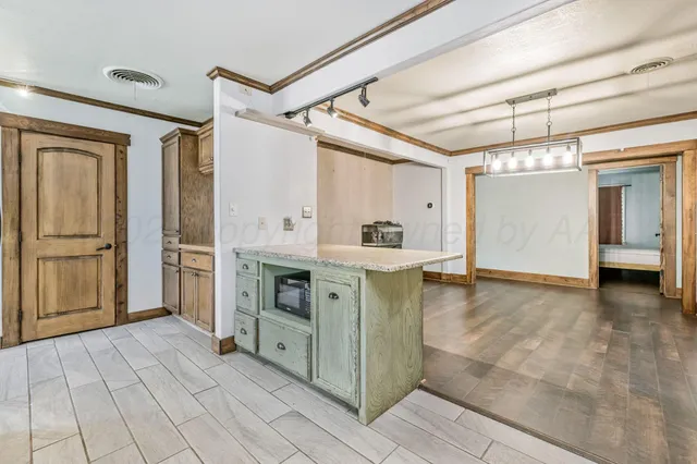 a view of a kitchen with a sink and a refrigerator