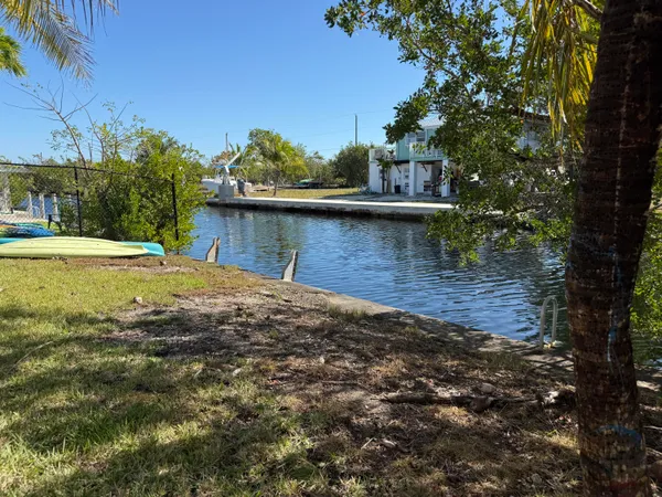 a living room with furniture a flat screen tv and a floor to ceiling window