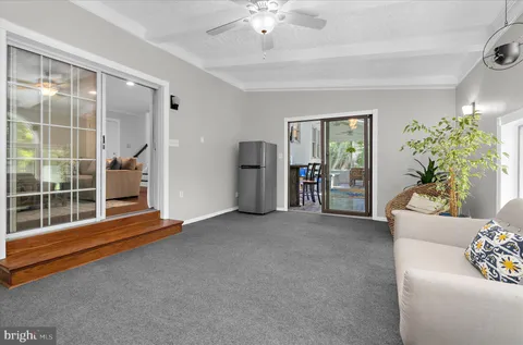 a spacious bedroom with a bed and a lamp on table