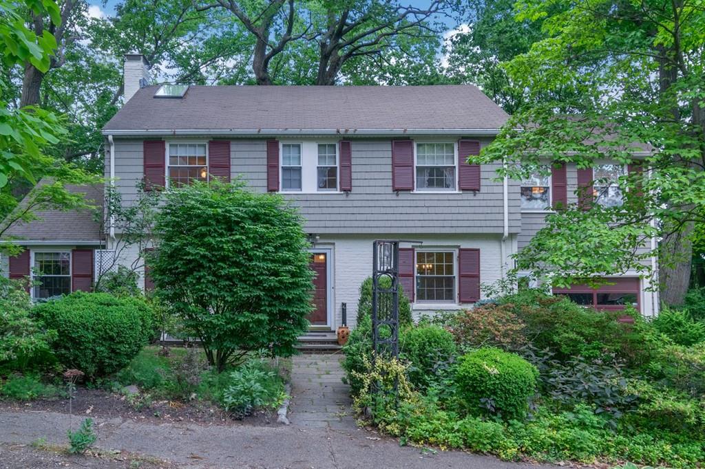 a house that has a tree in front of the house