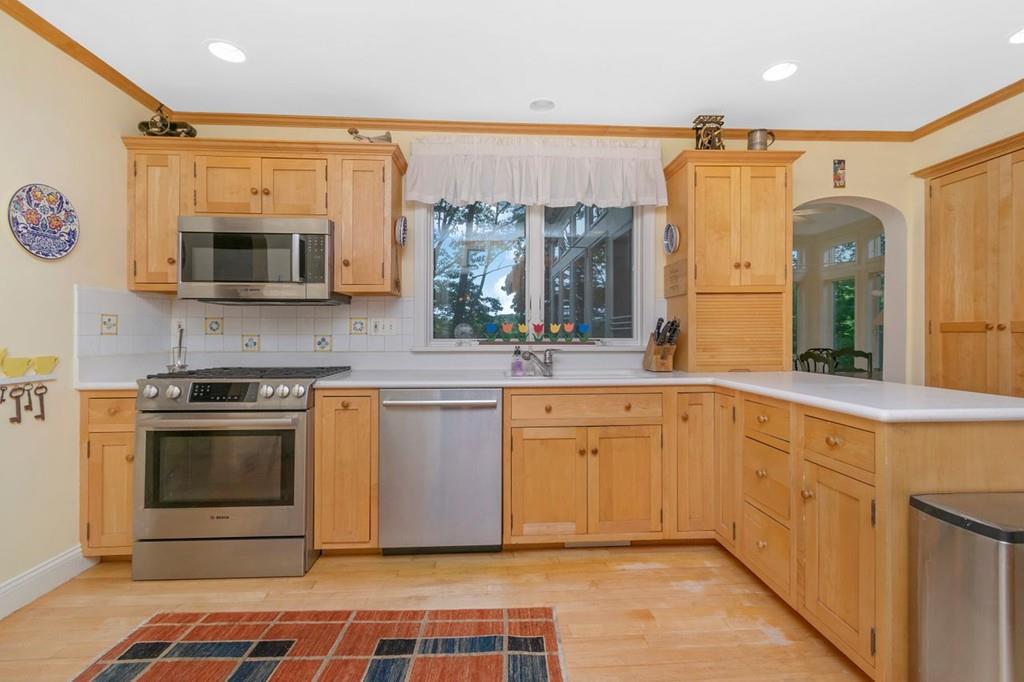 142 Kirkstall Road Newton, MA 02460 - Photo 11 of 23 a kitchen with stainless steel appliances granite countertop a stove a sink and a microwave