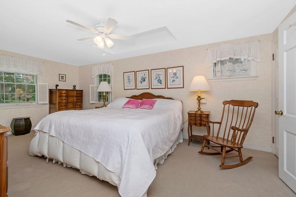 142 Kirkstall Road Newton, MA 02460 - Photo 16 of 23 a bedroom with a bed and a chandelier