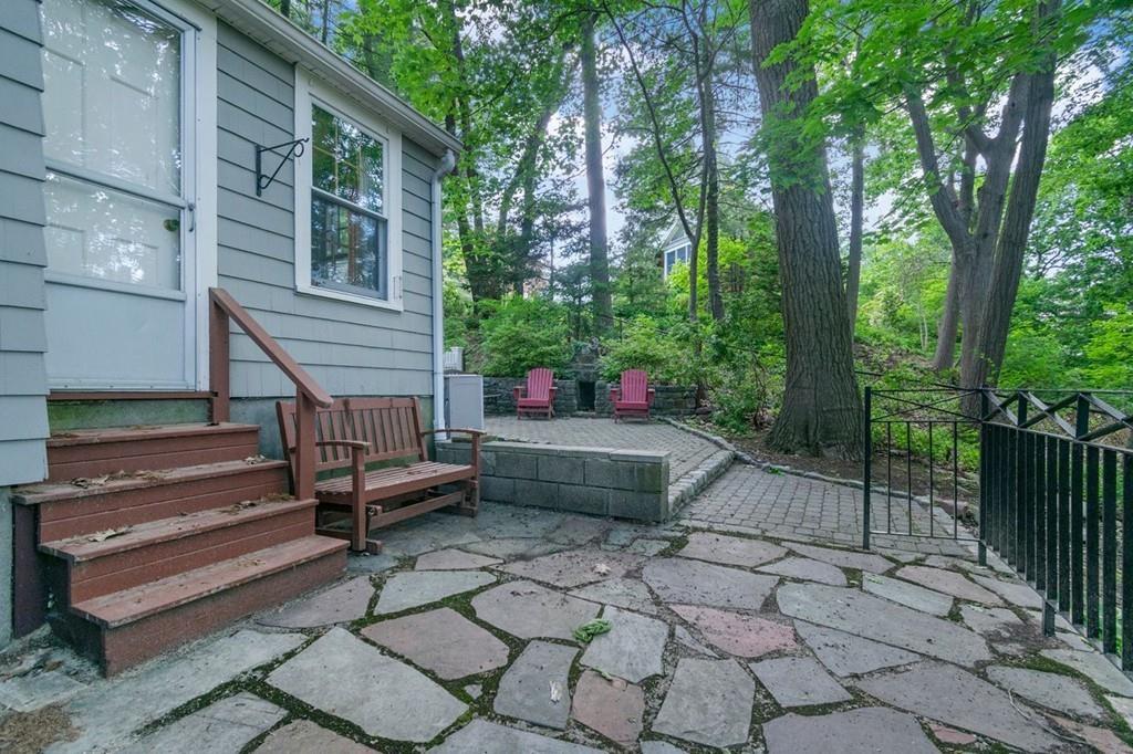 142 Kirkstall Road Newton, MA 02460 - Photo 22 of 23 a view of house with backyard outdoor seating and trees