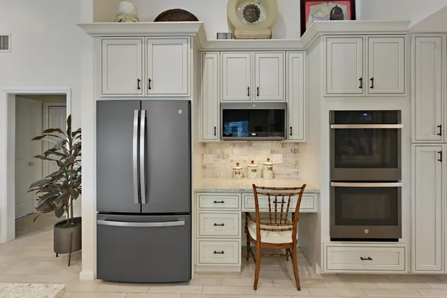 a kitchen with stainless steel appliances a refrigerator a stove a microwave and cabinets