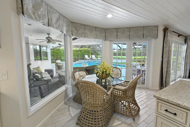 a dining room with furniture a chandelier and fireplace