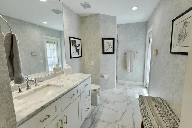 a spacious bathroom with a granite countertop sink toilet and shower