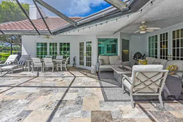 a view of a patio with a dining table and chairs