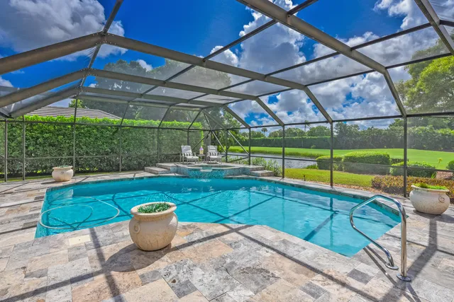 a view of a patio with a table and chairs under an umbrella