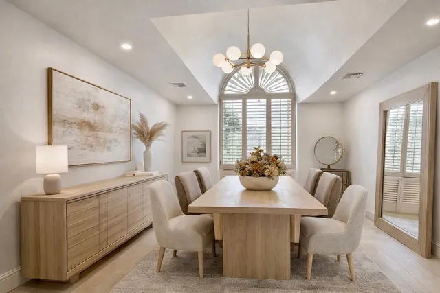 a living room with furniture chandelier and a large window