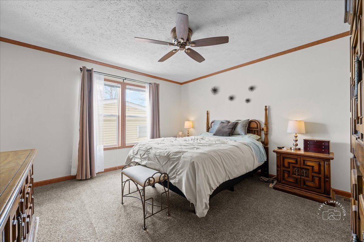 1116 Lakeview Road Elgin, IL 60123 - Photo 11 of 17 a spacious bedroom with a bed and a chandelier