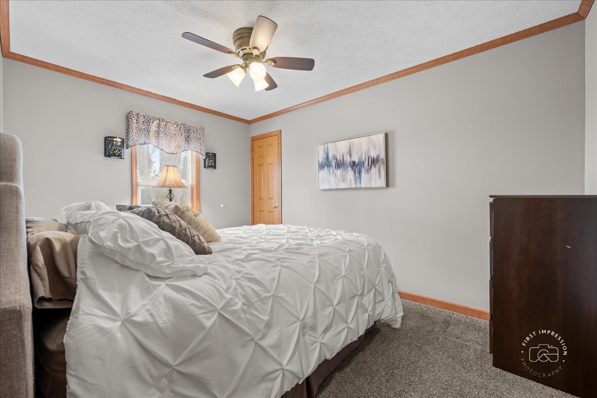 1116 Lakeview Road Elgin, IL 60123 - Photo 15 of 17 a bedroom with a bed and a chandelier