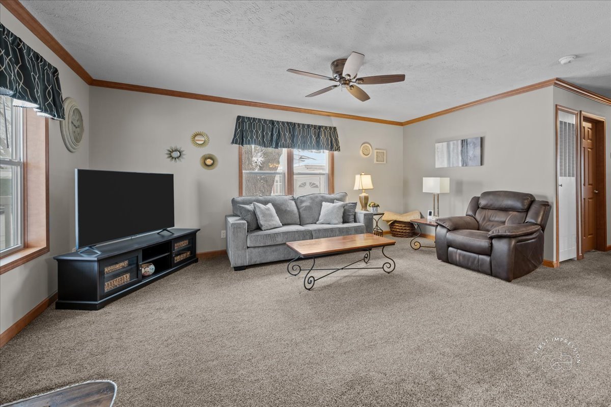 1116 Lakeview Road Elgin, IL 60123 - Photo 3 of 17 a living room with furniture and a flat screen tv