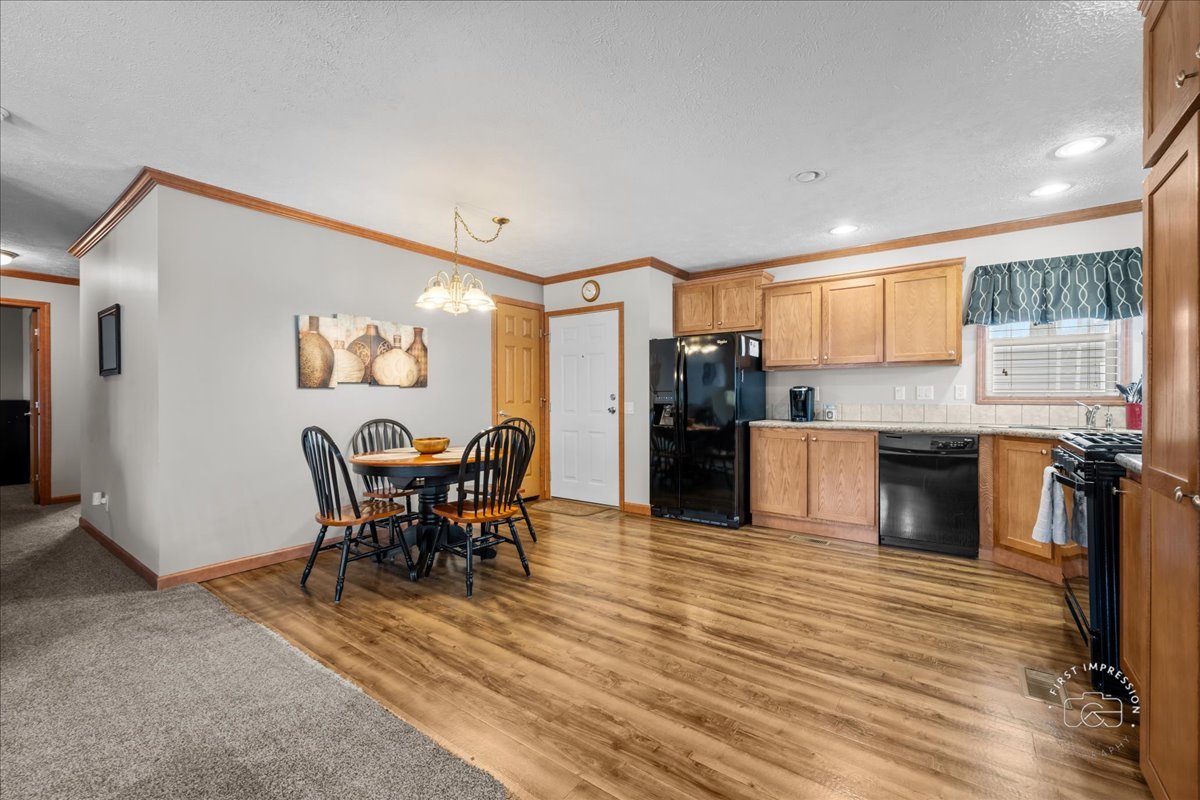 1116 Lakeview Road Elgin, IL 60123 - Photo 7 of 17 a kitchen with stainless steel appliances kitchen island granite countertop a table and chairs in it