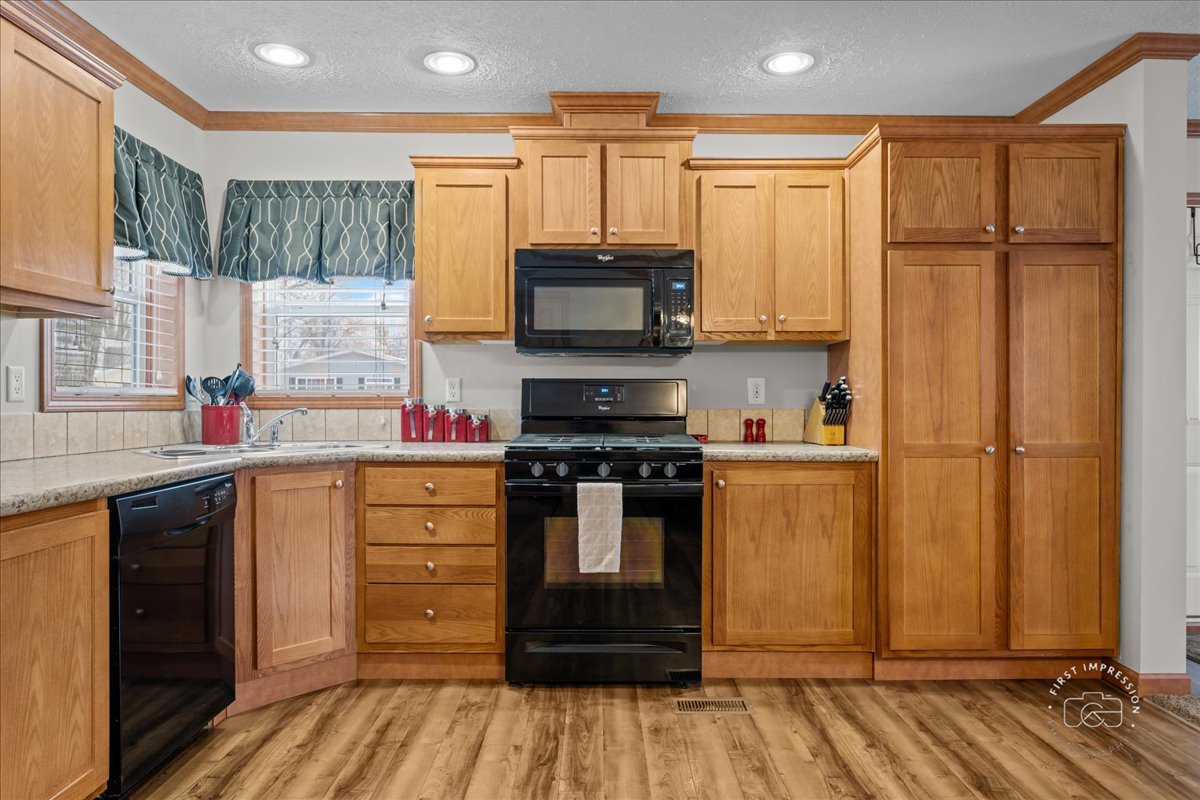 1116 Lakeview Road Elgin, IL 60123 - Photo 9 of 17 a kitchen with stainless steel appliances granite countertop a stove and a refrigerator