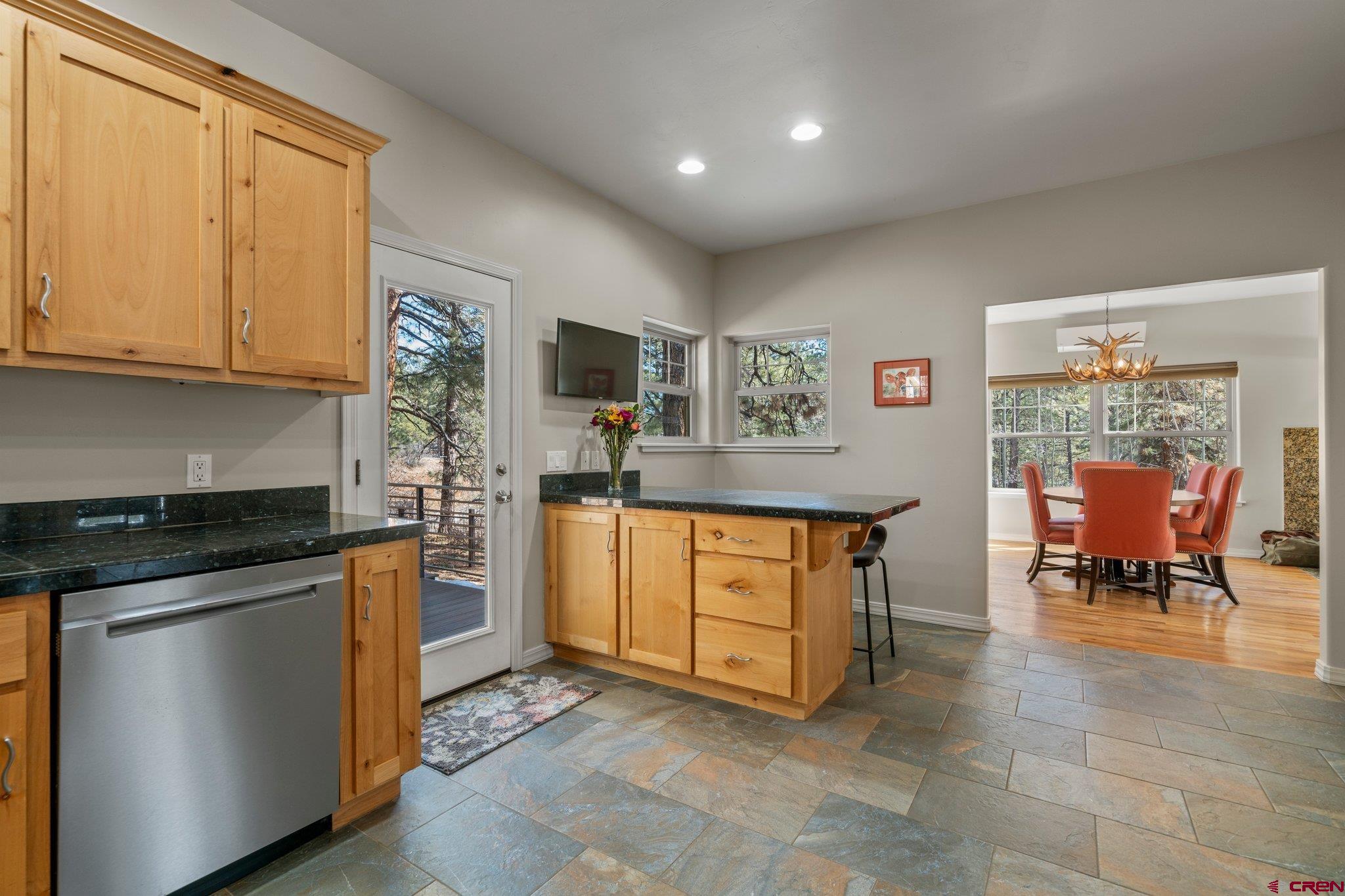 6072 County Road 240 Durango, CO 81301 - Photo 11 of 35 a kitchen with stainless steel appliances granite countertop a stove a sink and a refrigerator