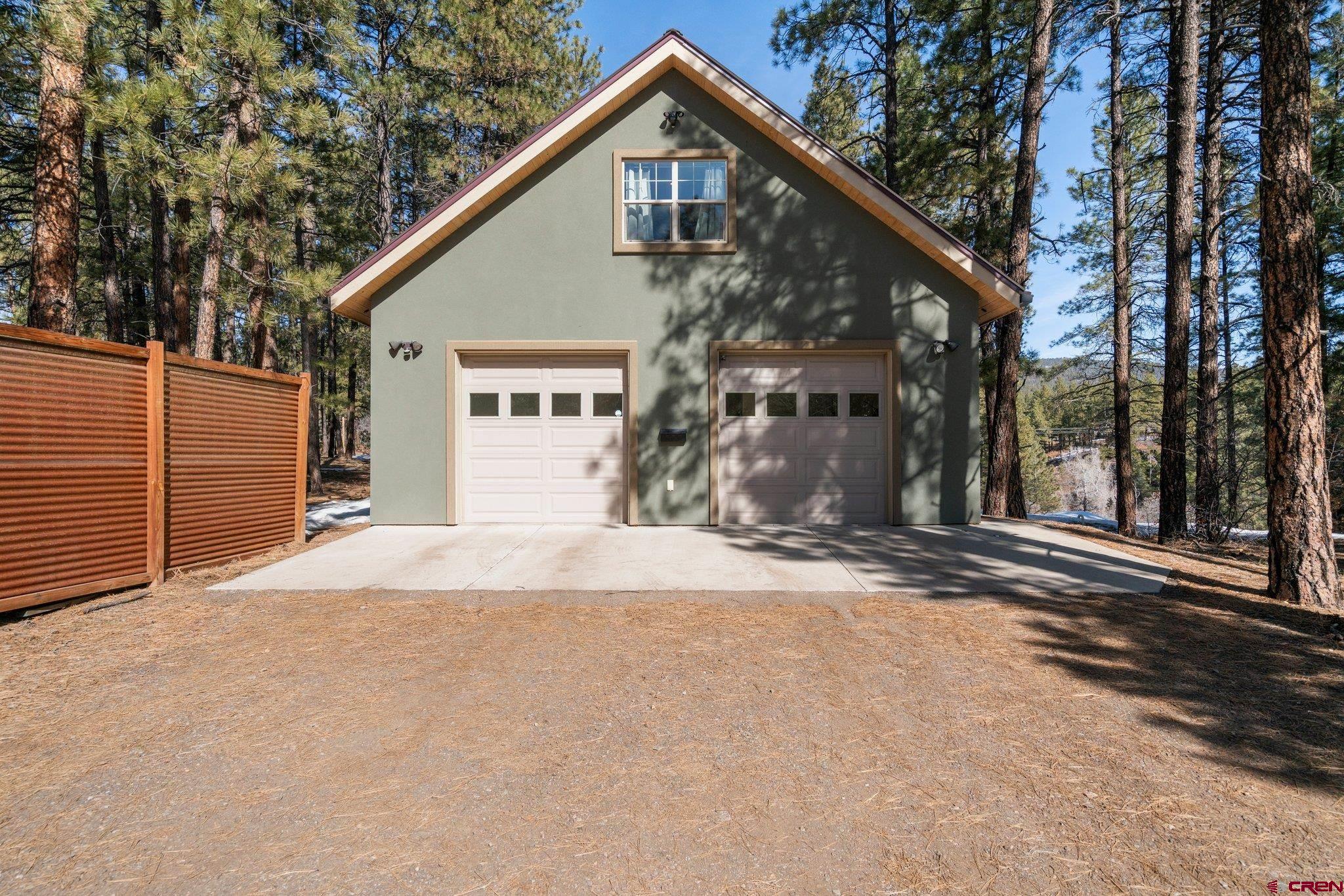 6072 County Road 240 Durango, CO 81301 - Photo 31 of 35 a front view of a house with a yard and garage